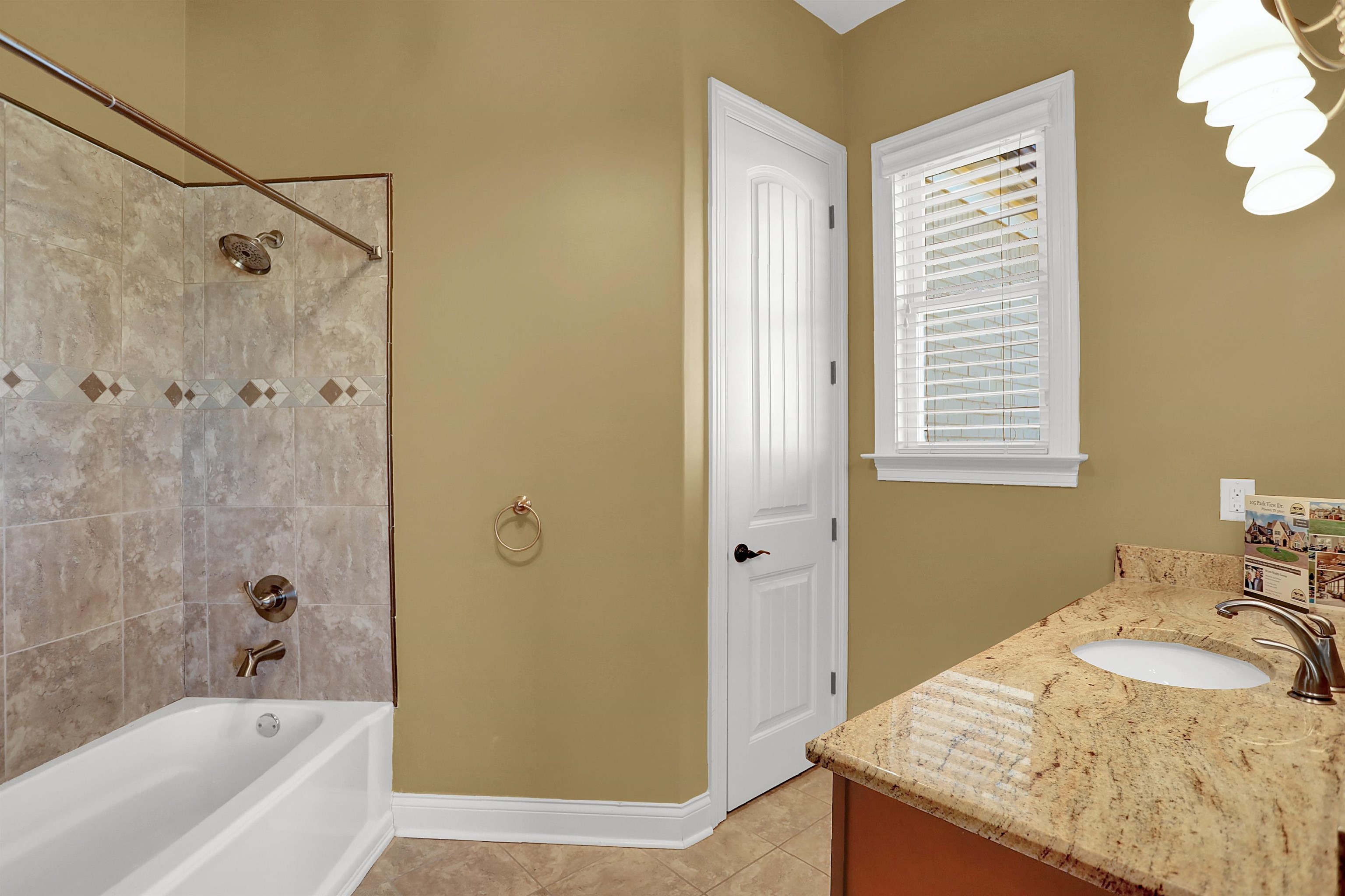 105 Parkview Drive Piperton, TN 38017 - Photo 14 of 25 a bathroom with a granite countertop sink a mirror and a bathtub