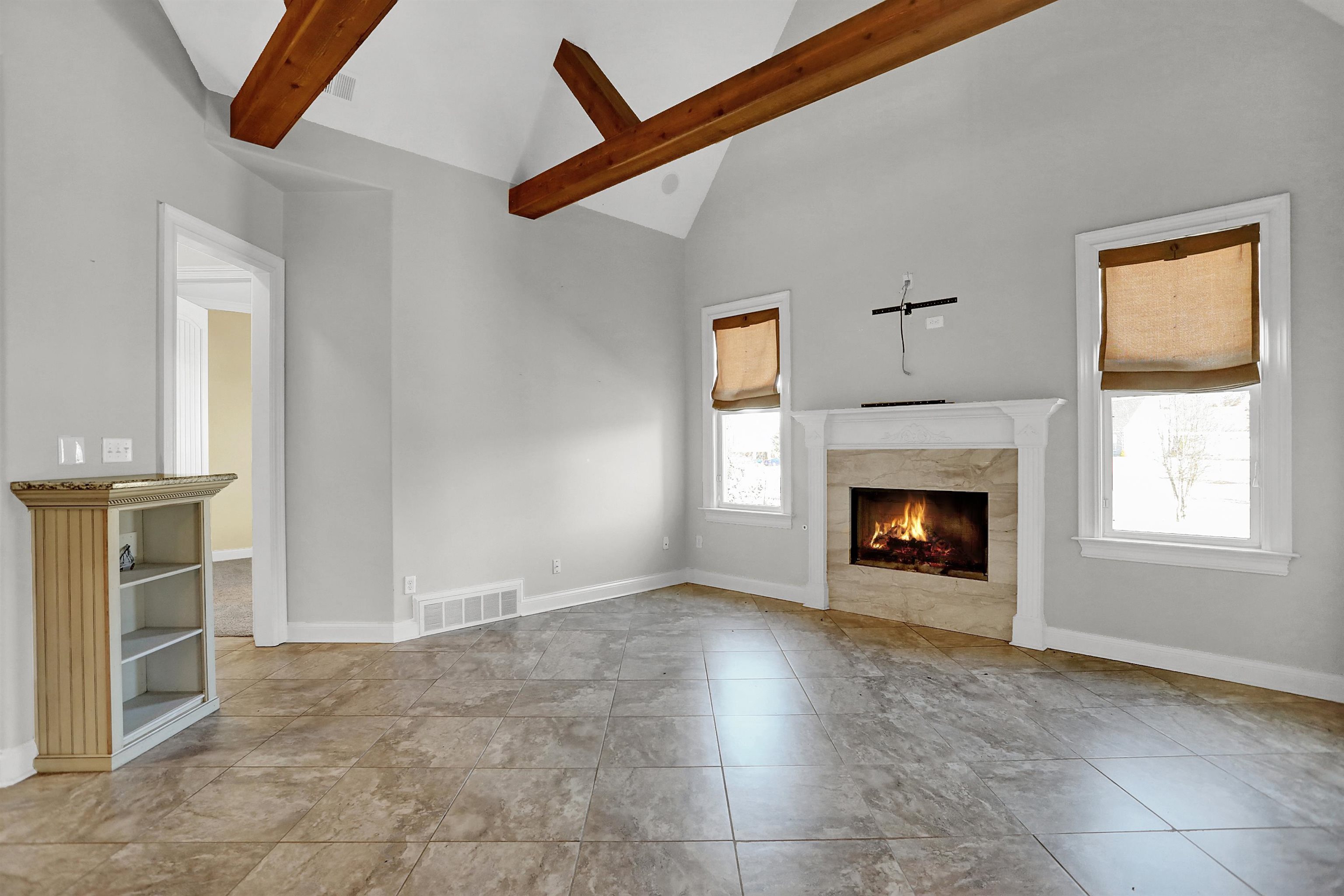 105 Parkview Drive Piperton, TN 38017 - Photo 9 of 25 a view of an empty room with a fireplace and a window