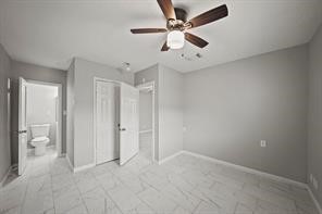 2002 Mustang Road, Unit 2 Alvin, TX 77511 - Photo 7 of 8 an empty room with fan and a ceiling fan