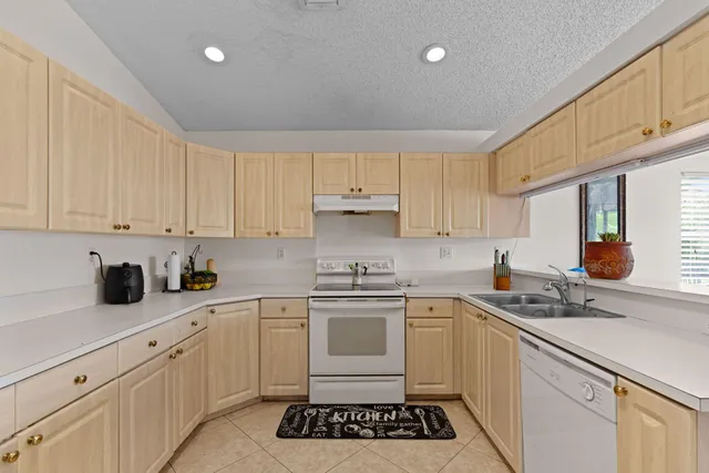 a kitchen with a sink stove and cabinets