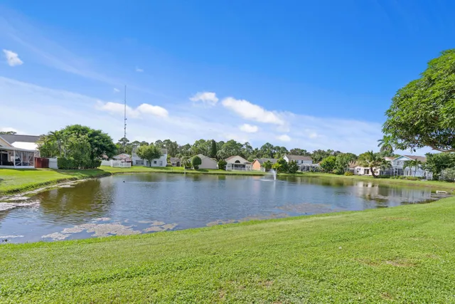 a view of a lake with houses in the back