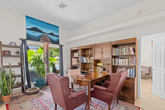 a living room with furniture and a floor to ceiling window