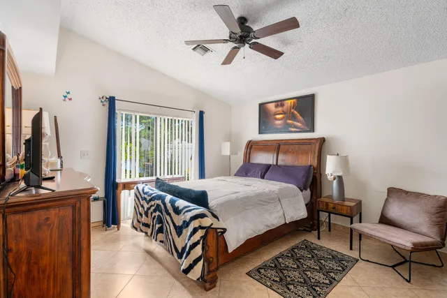 a bedroom with a bed couch and a window