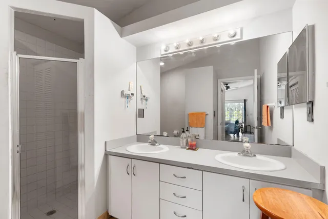 a bathroom with a double vanity sink and a mirror
