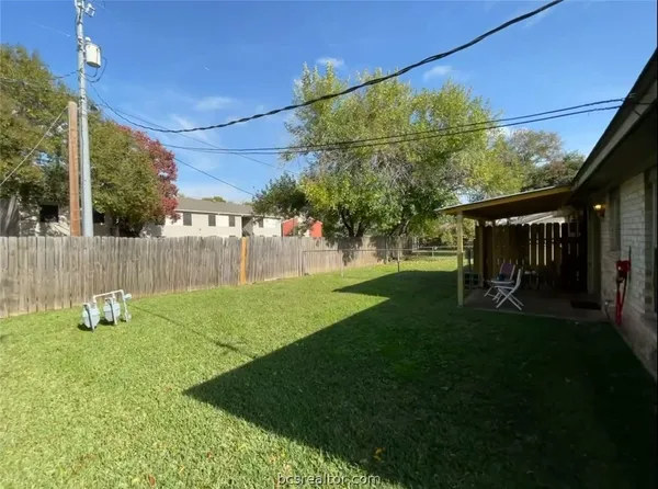 a view of backyard with house and green space