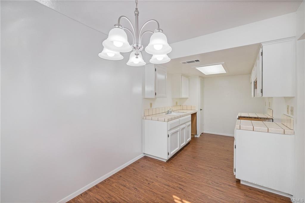 49400 River Park Road, Unit 17 Oakhurst, CA 93644 - Photo 31 of 34 a kitchen with a sink cabinets and wooden floor