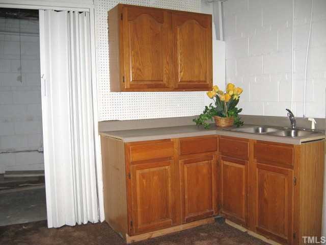 3819 Corwin Road Garner, NC 27529 - Photo 11 of 12 Basement utility room with built-in sink & cabinets