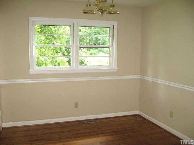 3819 Corwin Road Garner, NC 27529 - Photo 5 of 12 Formal dining room with chair rail & hardwoods