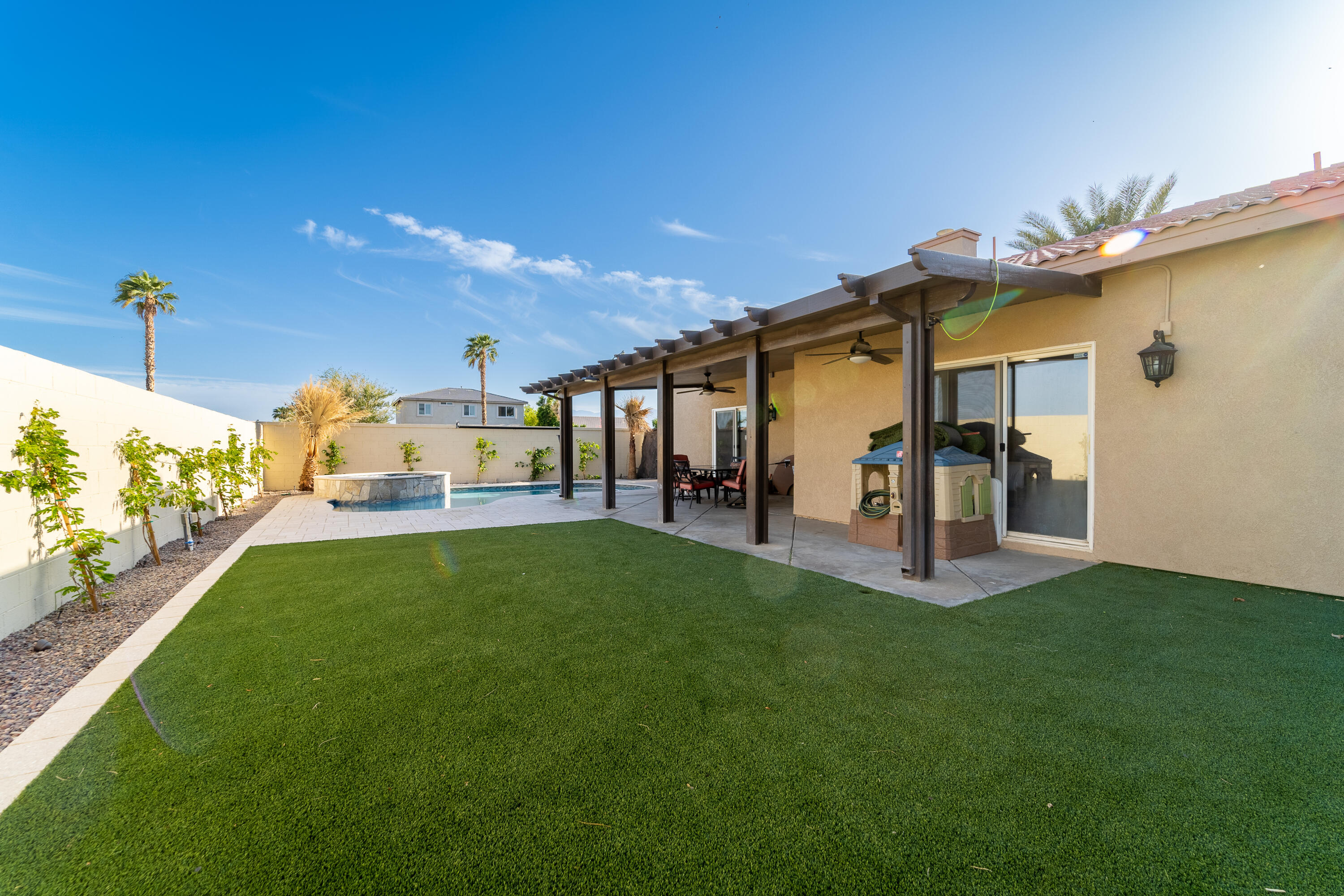 47970 Austin Drive Indio, CA 92201 - Photo 29 of 32 a front view of a house with a garden