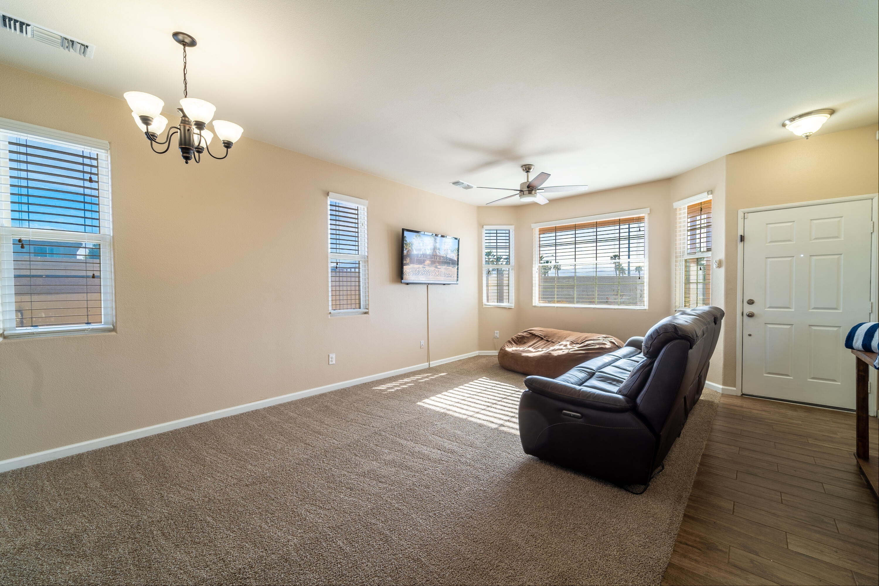 47970 Austin Drive Indio, CA 92201 - Photo 6 of 32 a living room with furniture and a chandelier