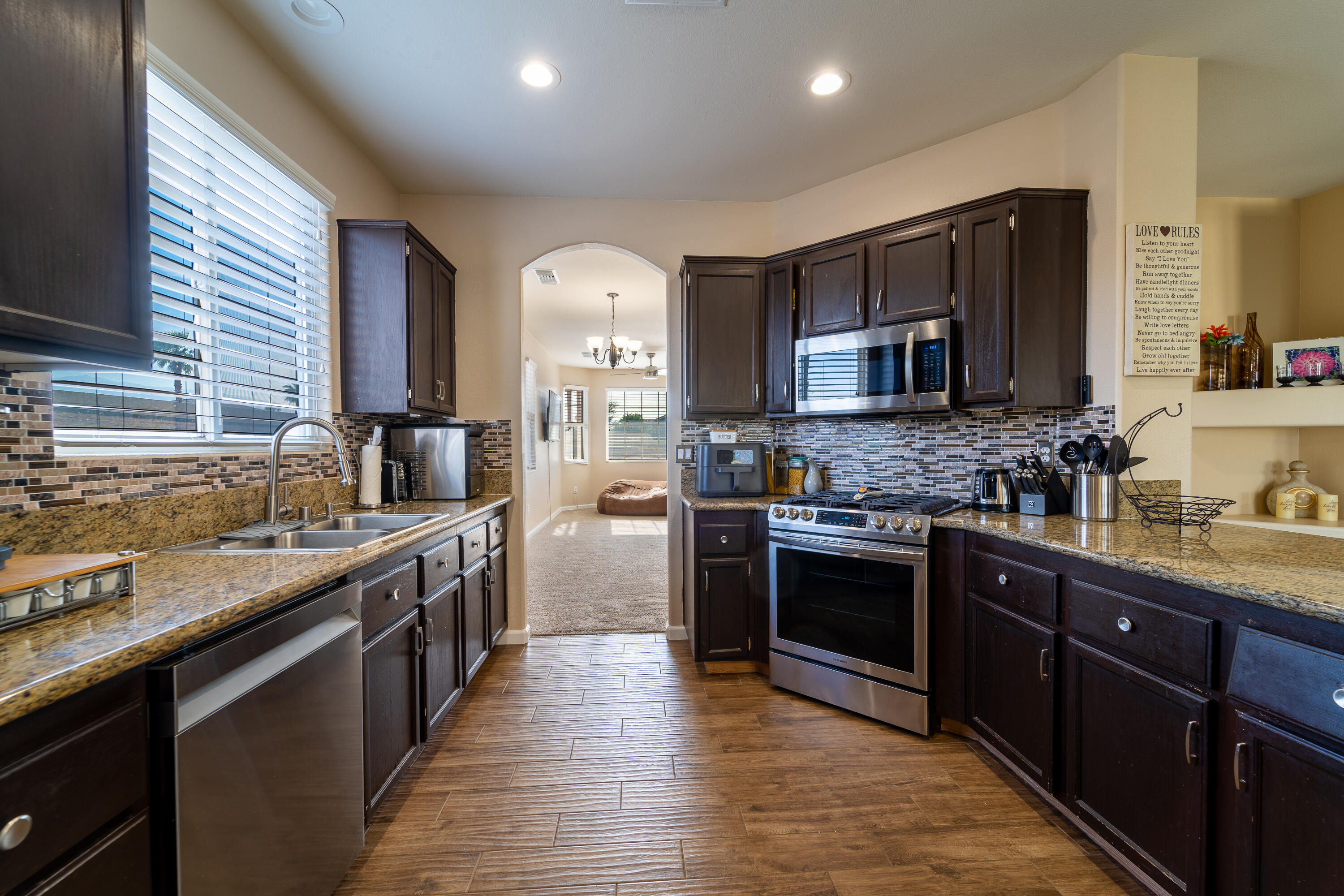 47970 Austin Drive Indio, CA 92201 - Photo 7 of 32 a kitchen with stainless steel appliances granite countertop wooden cabinets a sink dishwasher a stove and a refrigerator