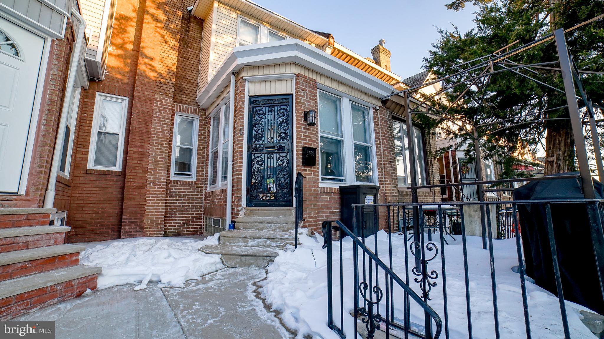 a view of a house with wooden fence