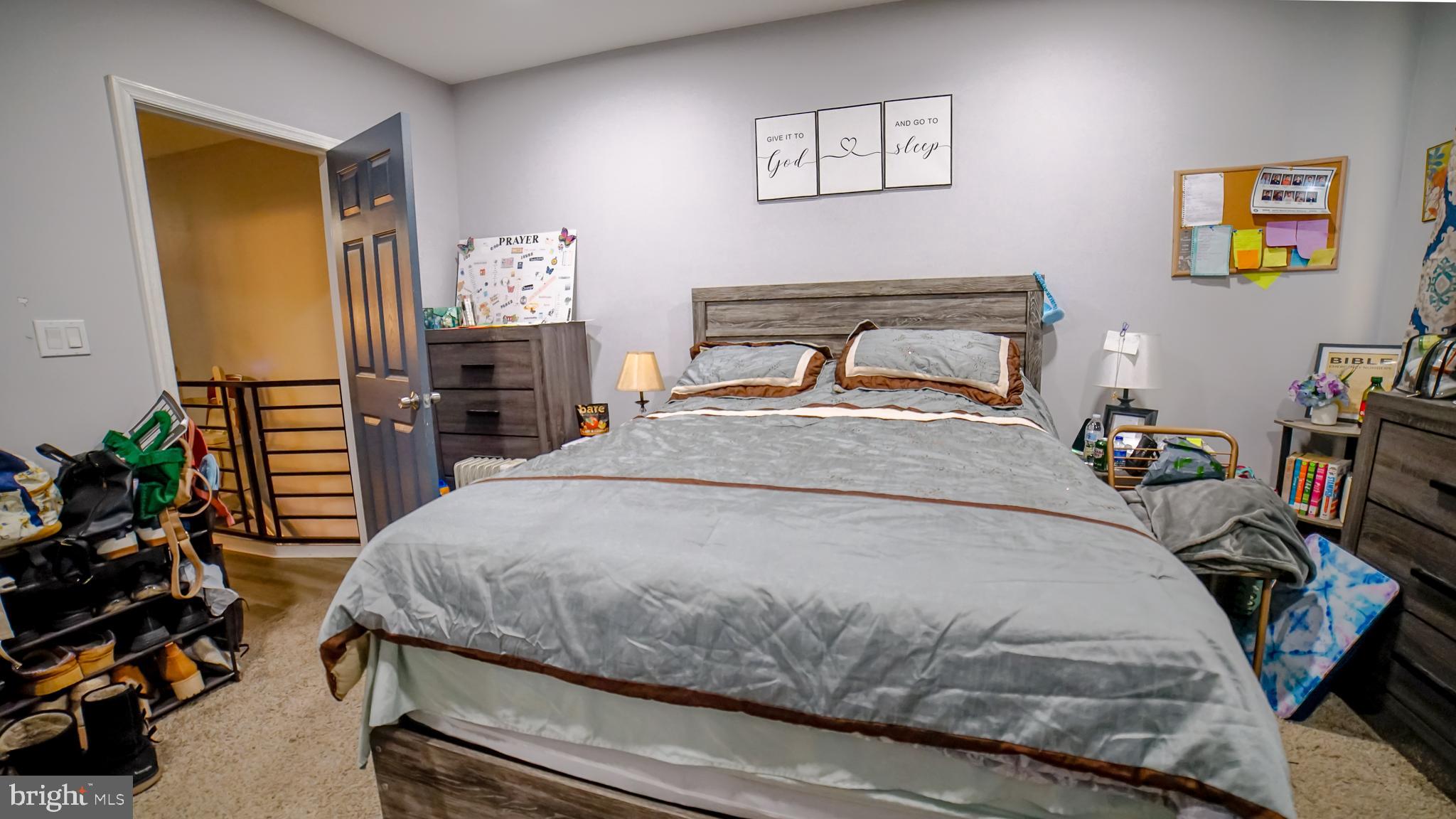 5635 North 10th Street Philadelphia, PA 19141 - Photo 5 of 13 a bedroom with a bed and wooden floor