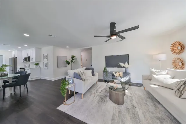 a living room with furniture wooden floor and a chandelier
