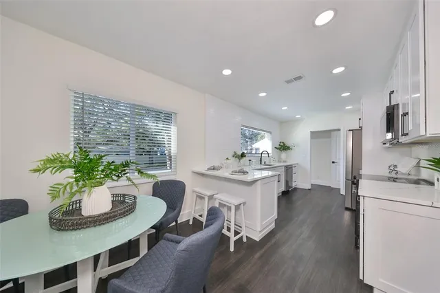 a kitchen with a table and chairs
