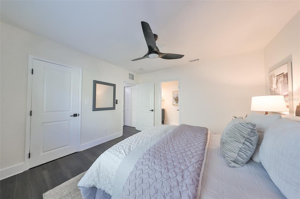 1846 3rd Street South St. Petersburg, FL 33705 - Photo 24 of 40 a bedroom with a large bed and a chandelier