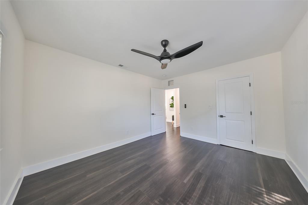 1846 3rd Street South St. Petersburg, FL 33705 - Photo 27 of 40 an empty room with wooden floor and a ceiling fan