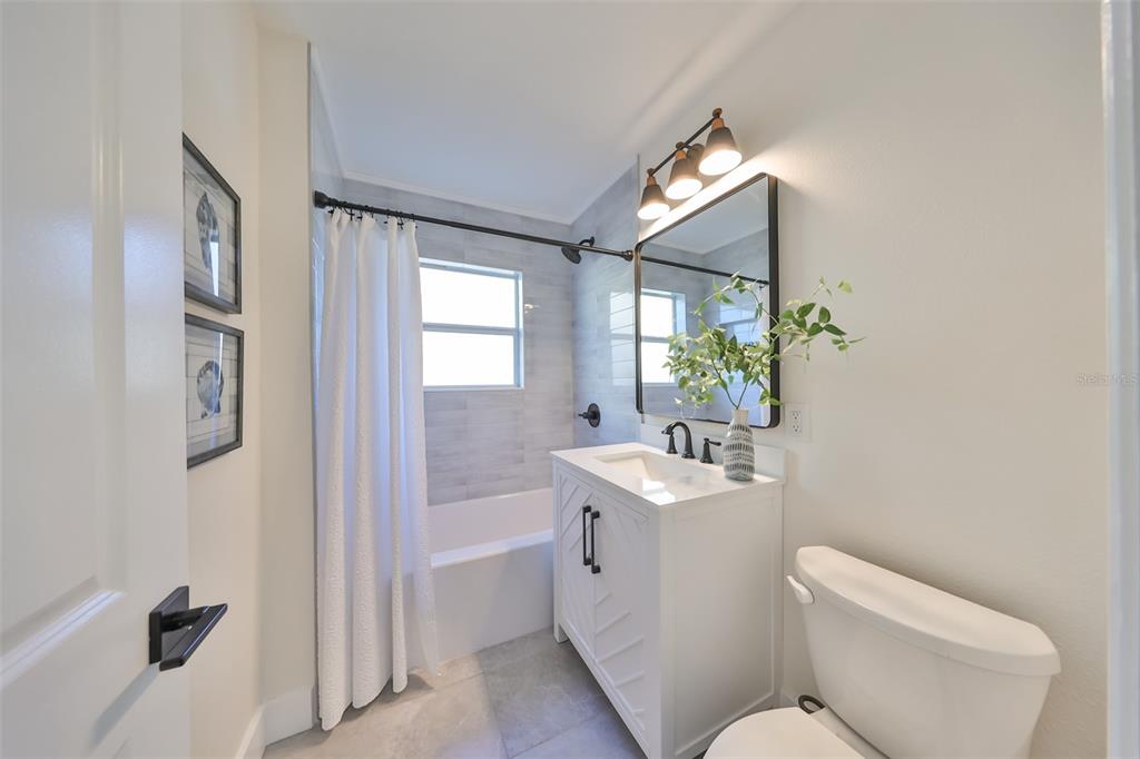 1846 3rd Street South St. Petersburg, FL 33705 - Photo 29 of 40 a bathroom with a toilet sink and mirror