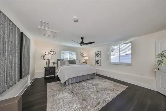 a spacious bedroom with a bed and a window