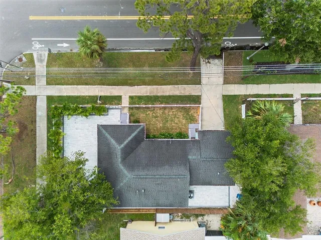 an aerial view of a house with a yard