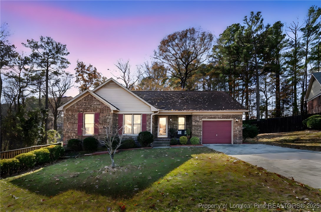 5004 Summer Ridge Road Fayetteville, NC 28303 - Photo 1 of 31 a front view of a house with a yard and garage