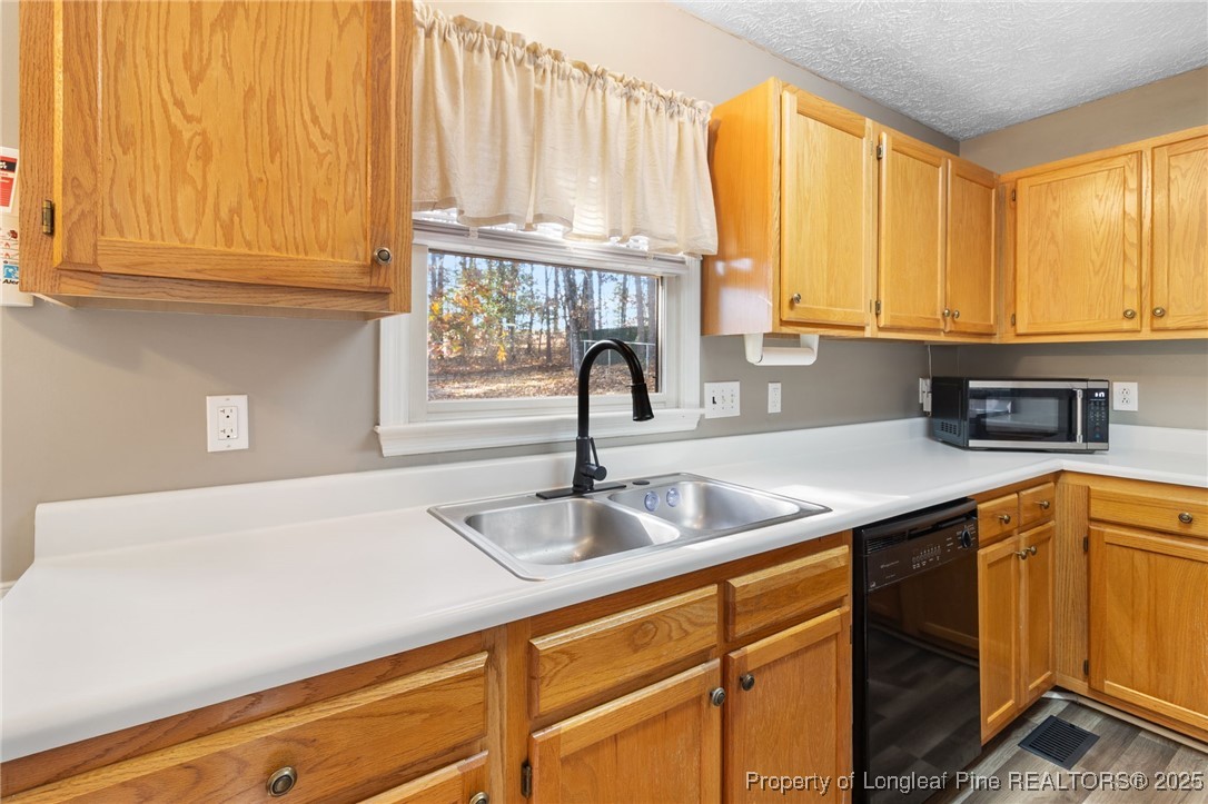 5004 Summer Ridge Road Fayetteville, NC 28303 - Photo 13 of 31 a kitchen with granite countertop a sink and a window