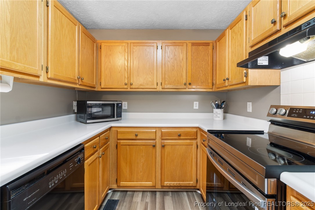5004 Summer Ridge Road Fayetteville, NC 28303 - Photo 14 of 31 a kitchen with a sink and cabinets
