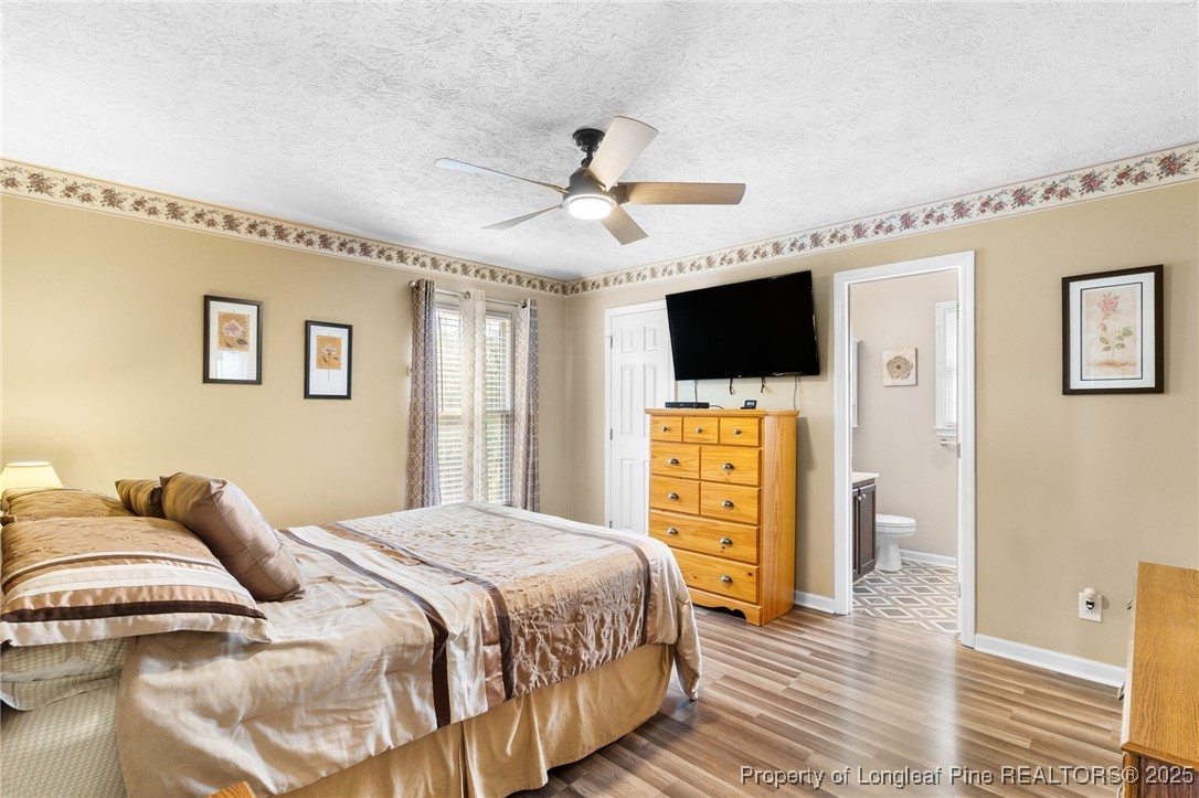 5004 Summer Ridge Road Fayetteville, NC 28303 - Photo 16 of 31 a bedroom with a bed and a flat screen tv
