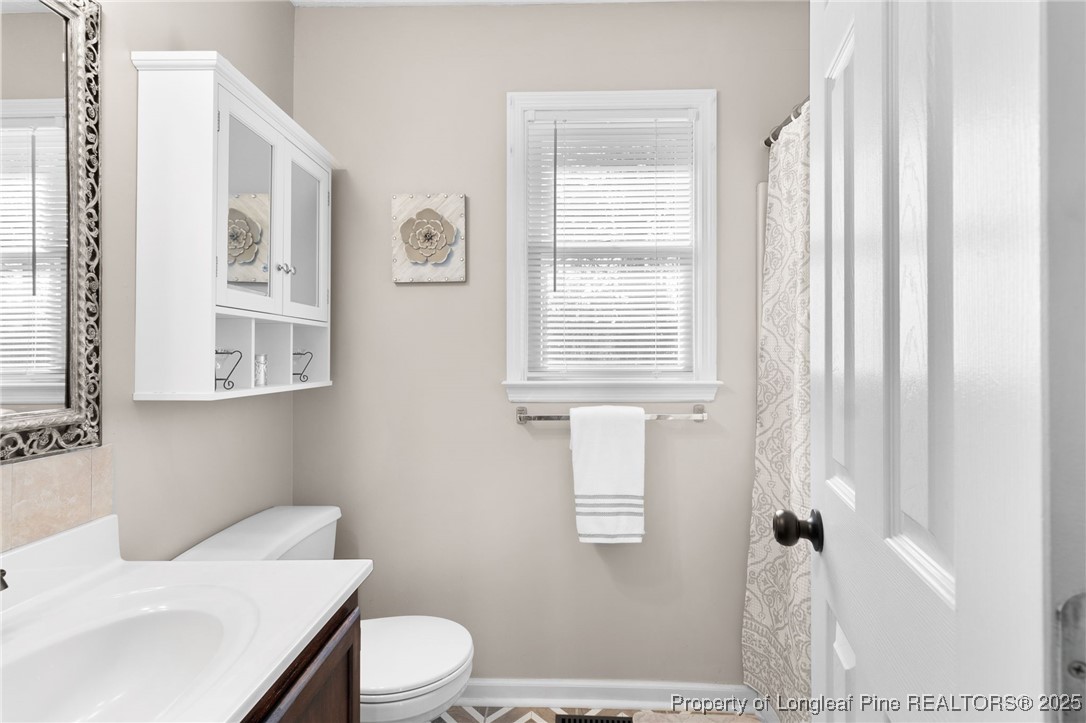 5004 Summer Ridge Road Fayetteville, NC 28303 - Photo 18 of 31 a bathroom with a sink toilet and window