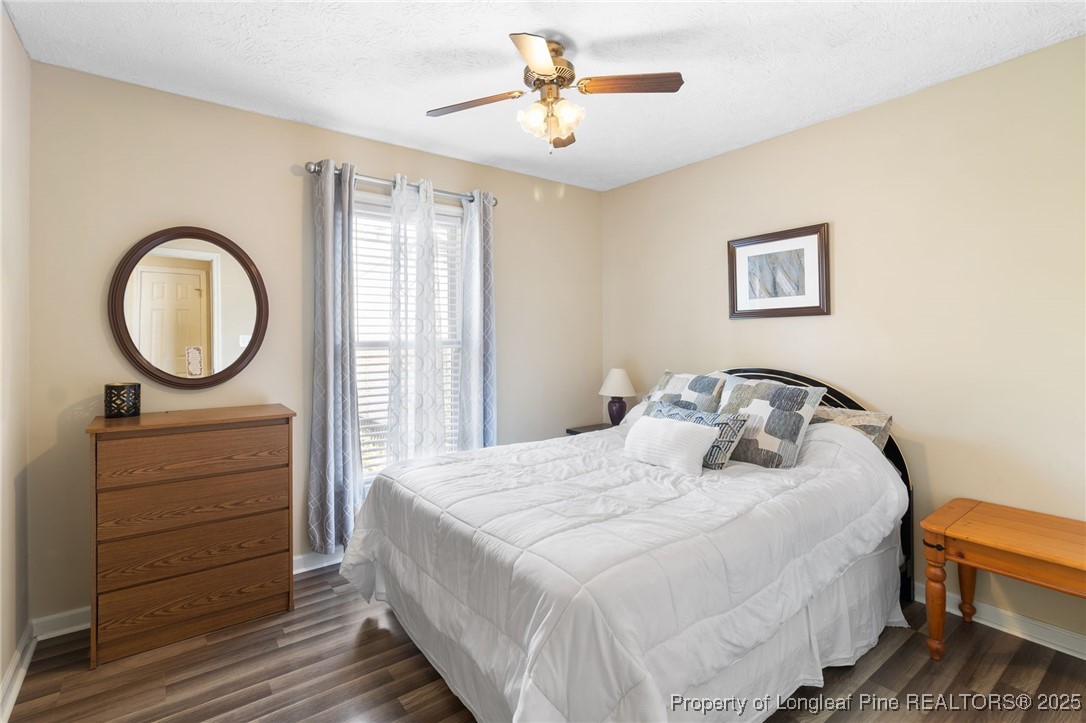5004 Summer Ridge Road Fayetteville, NC 28303 - Photo 20 of 31 a bedroom with a bed and a chandelier