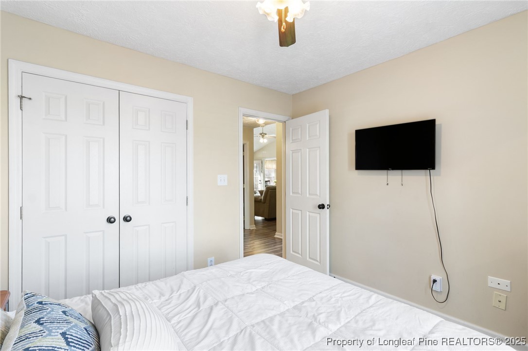 5004 Summer Ridge Road Fayetteville, NC 28303 - Photo 21 of 31 a bedroom with a bed and a flat screen tv
