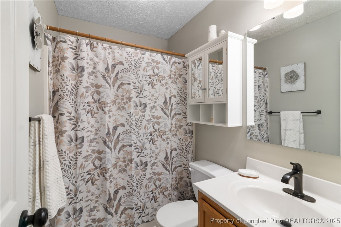 5004 Summer Ridge Road Fayetteville, NC 28303 - Photo 22 of 31 a bathroom with a sink toilet and shower