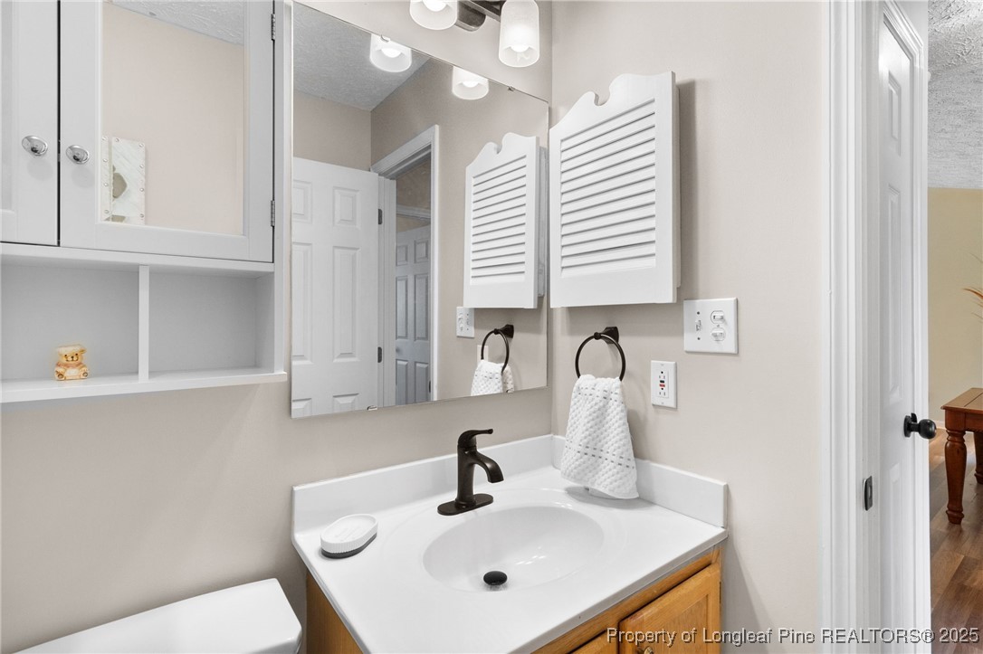 5004 Summer Ridge Road Fayetteville, NC 28303 - Photo 23 of 31 a bathroom with a sink and a mirror