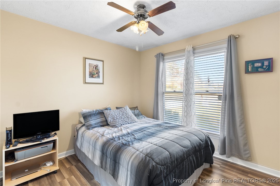 5004 Summer Ridge Road Fayetteville, NC 28303 - Photo 24 of 31 a bedroom with a bed and a flat screen tv