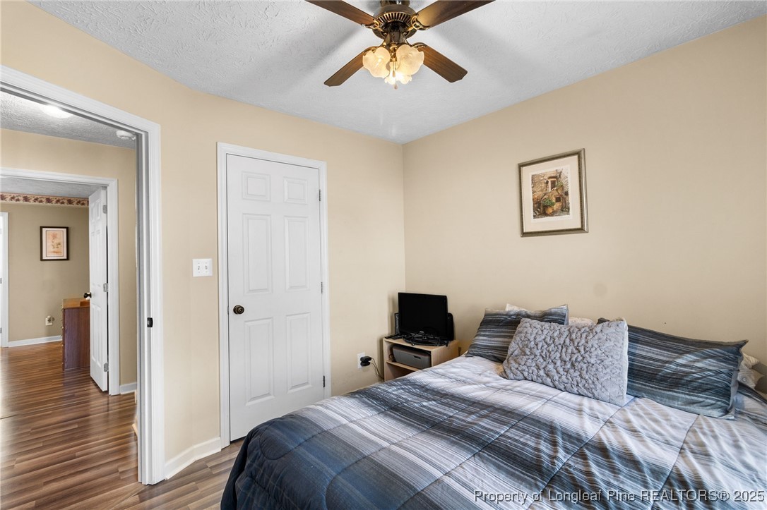 5004 Summer Ridge Road Fayetteville, NC 28303 - Photo 25 of 31 a bedroom with a bed and a chandelier