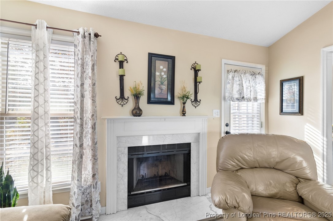 5004 Summer Ridge Road Fayetteville, NC 28303 - Photo 8 of 31 a living room with furniture and a fireplace