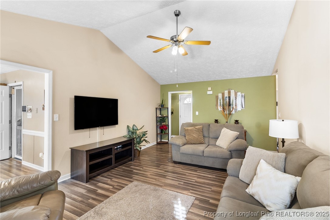 5004 Summer Ridge Road Fayetteville, NC 28303 - Photo 9 of 31 a living room with furniture and a flat screen tv