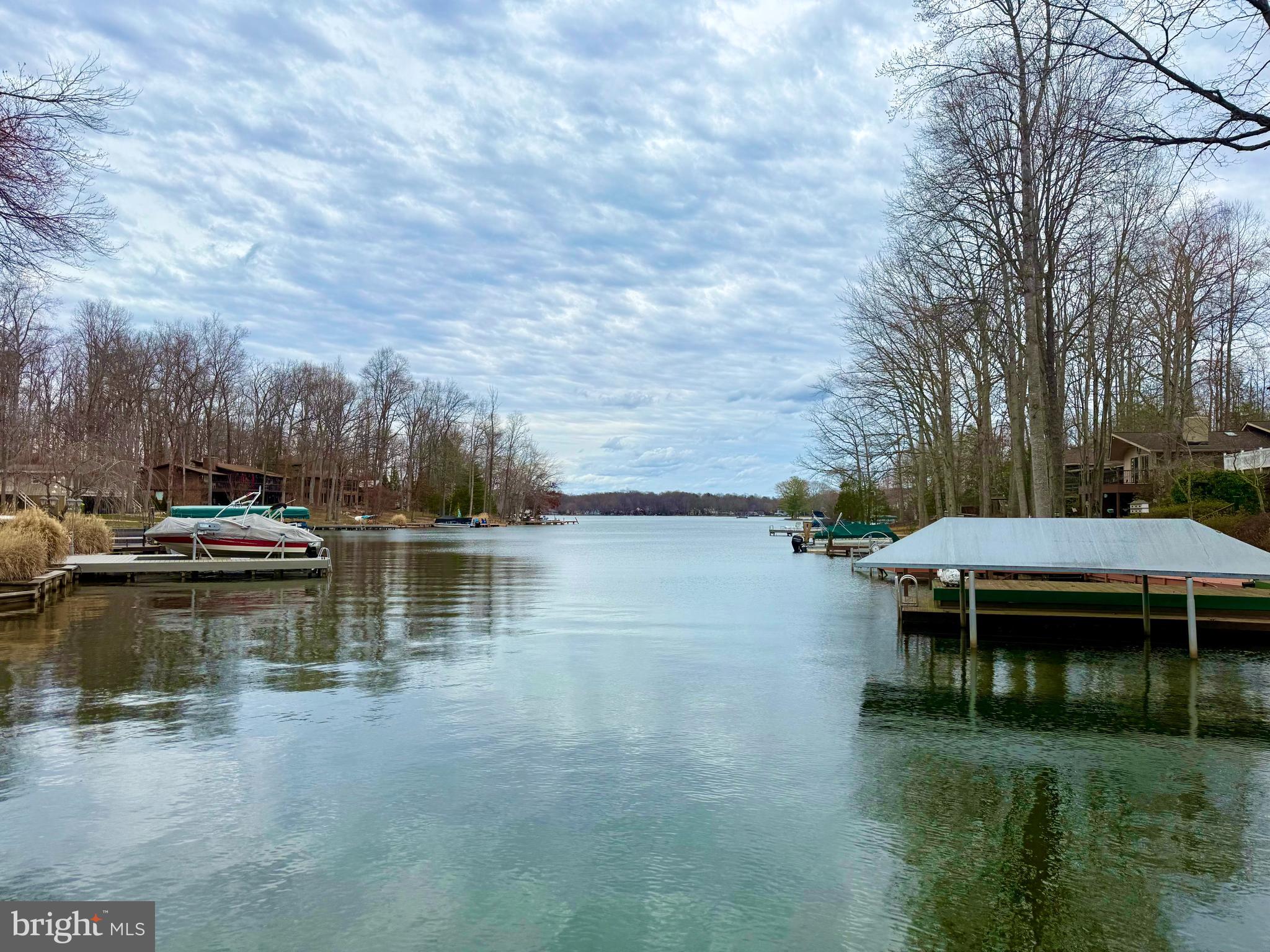 116 Washington Street Locust Grove, VA 22508 - Photo 4 of 130 a view of a lake with lawn chairs and a table