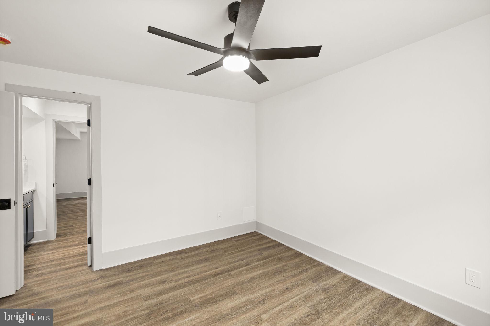 116 Washington Street Locust Grove, VA 22508 - Photo 75 of 130 a view of a room with wooden floor and a ceiling fan