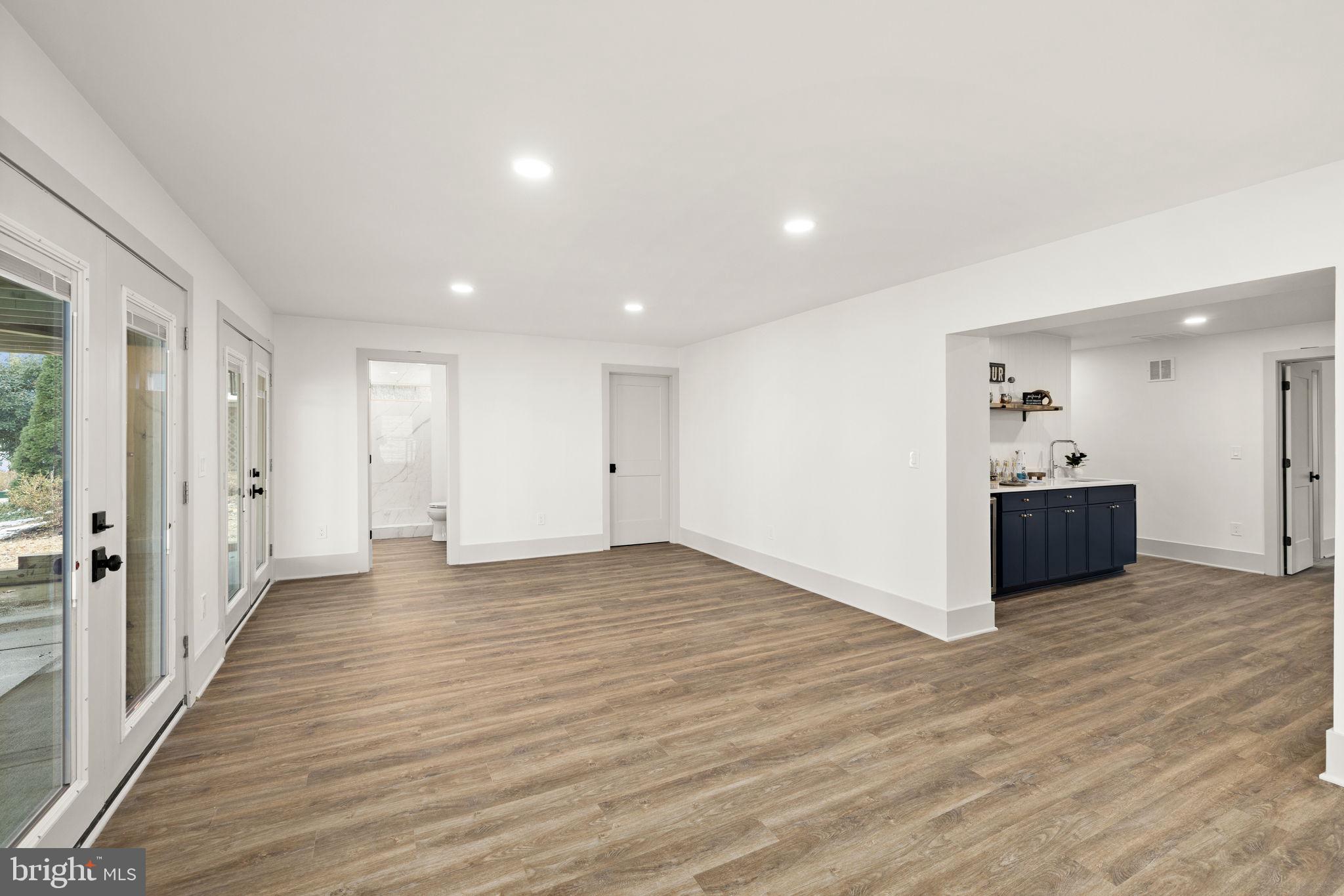 116 Washington Street Locust Grove, VA 22508 - Photo 84 of 130 a view of an empty room with wooden floor and a bathroom