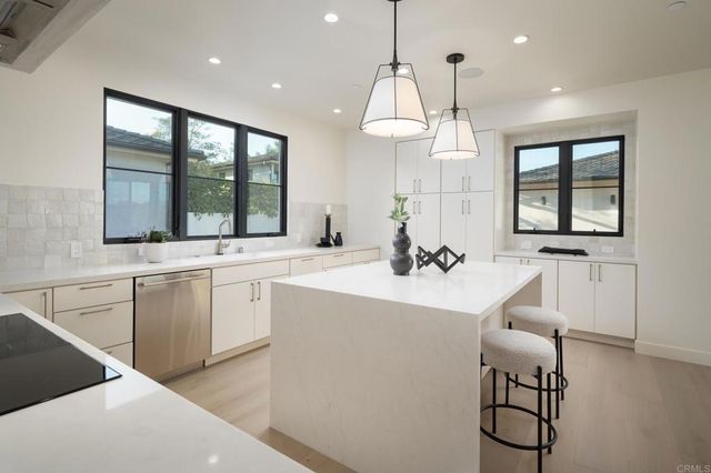 a kitchen with a sink and cabinets