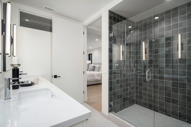 a bathroom with a double vanity sink and mirror