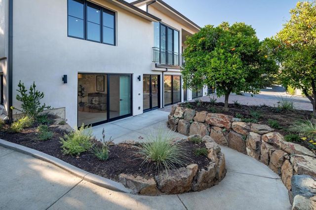 front view of a house with a yard and parking space