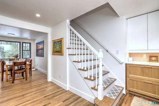 a view of entryway and hall with wooden floor