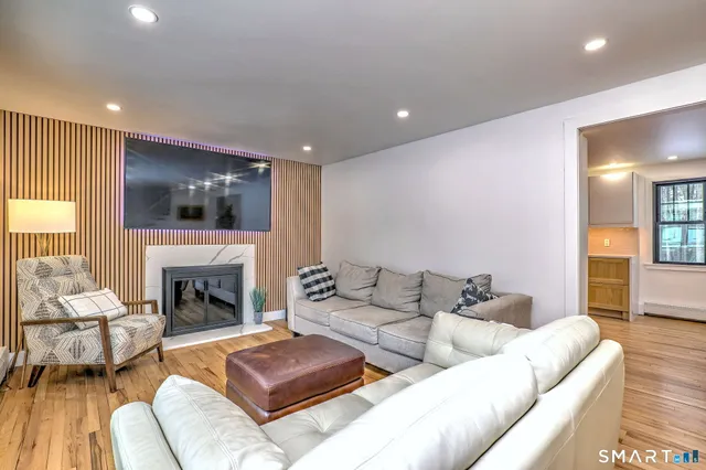 a living room with furniture fireplace and window
