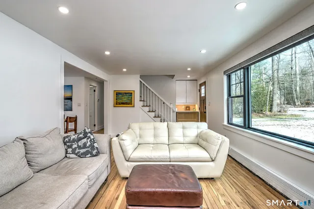 a living room with furniture and a large window