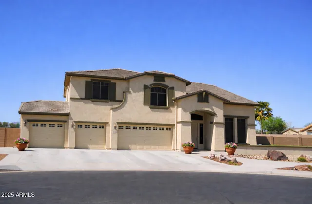 a view of a house with roof and parking space