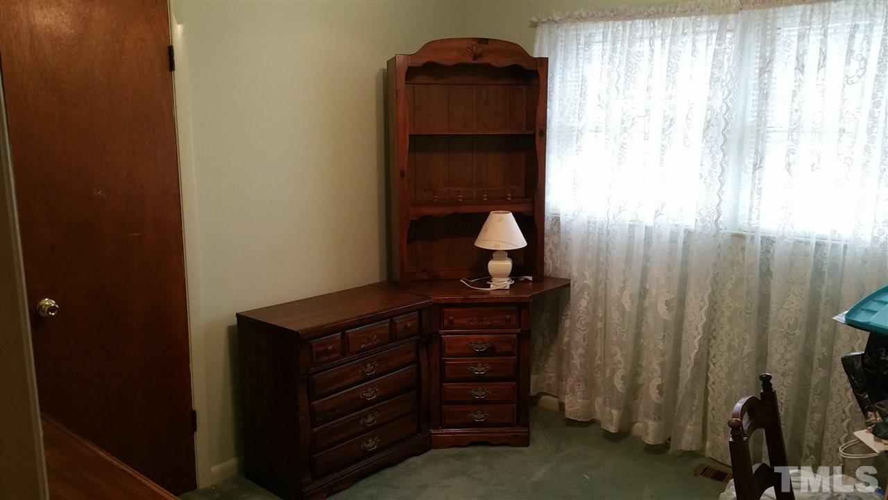 716 Cooper Road Raleigh, NC 27610 - Photo 11 of 25 a room with a bed and a dresser