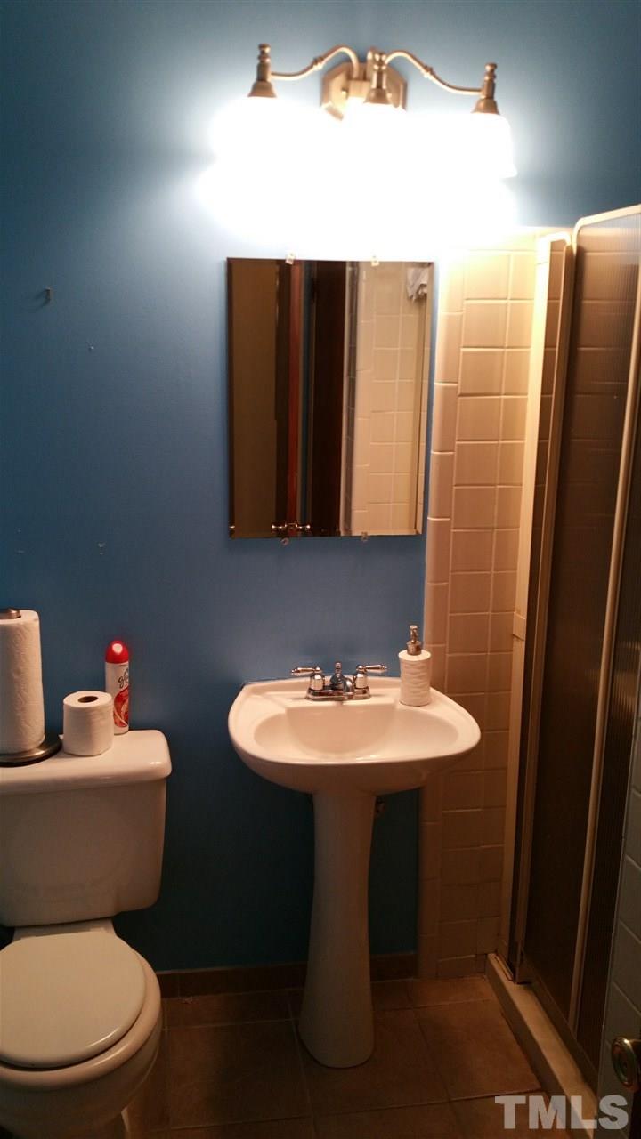 716 Cooper Road Raleigh, NC 27610 - Photo 14 of 25 a bathroom with a toilet sink and mirror