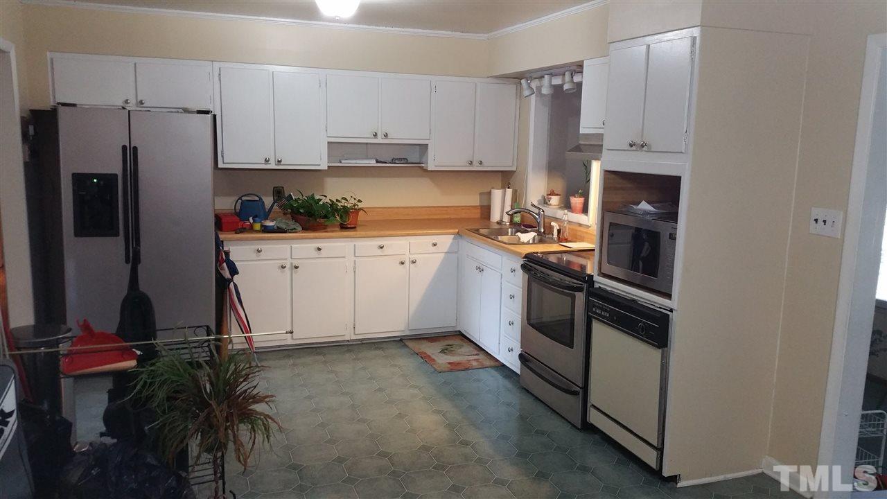 716 Cooper Road Raleigh, NC 27610 - Photo 4 of 25 a kitchen with stainless steel appliances granite countertop a refrigerator a stove and a sink